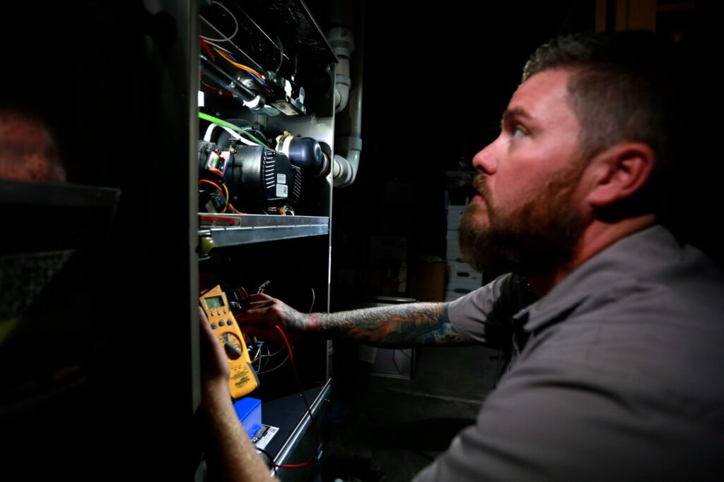 Technician servicing a furnace