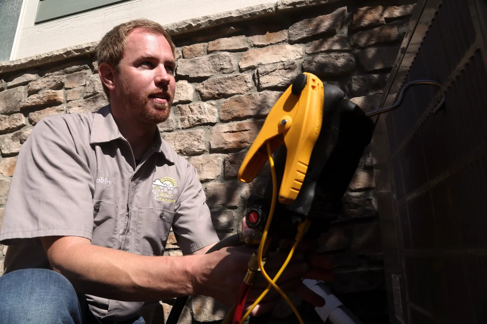 Technician working on an outdoor AC unit