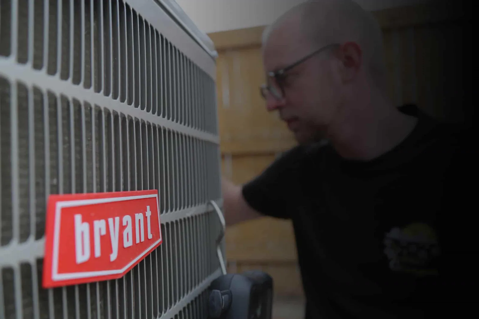 A Weather Changers technician working on a Bryant outdoor unit